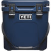 Blue YETI cooler with a black strap on a white background