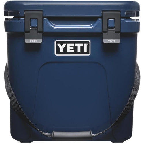 Blue YETI cooler with a black strap on a white background